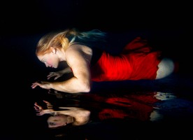 underwater model red dress reflection