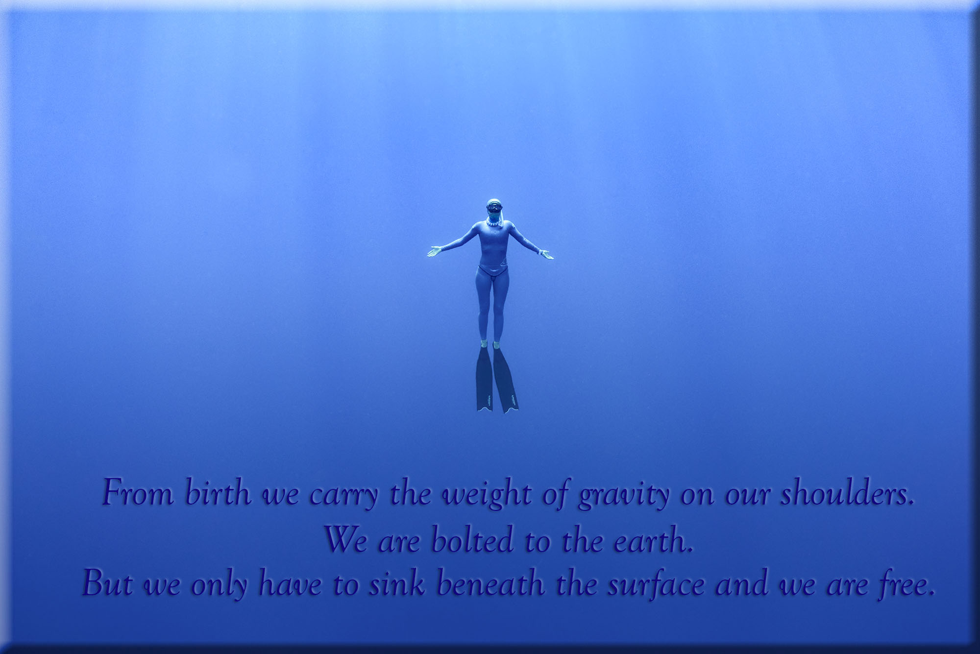 Freediver in blue water off the coast of Kona