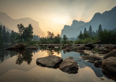 The Merced River winds it's way through Yosemite Valley in the early morning light enhanced by smoke from nearby wildfires.