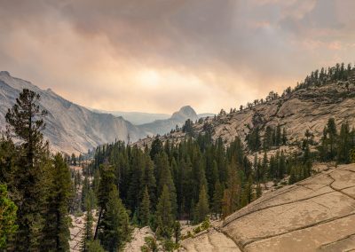 View of Half Dome from Tioga Pass area in Yosemite National Park with smoky sky from nearby forest fires
